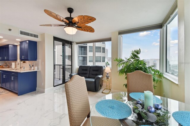 dining room with visible vents, marble finish floor, a ceiling fan, and baseboards