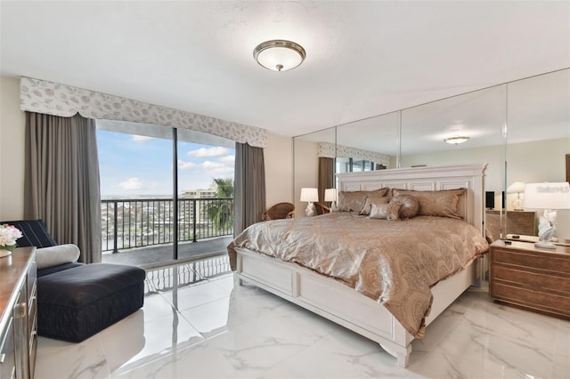 bedroom with access to exterior and marble finish floor