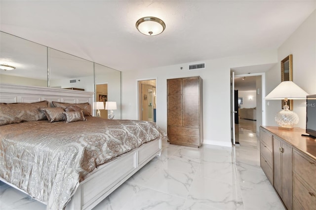 bedroom featuring baseboards, visible vents, and marble finish floor