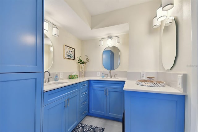 bathroom with tile patterned flooring, double vanity, and a sink