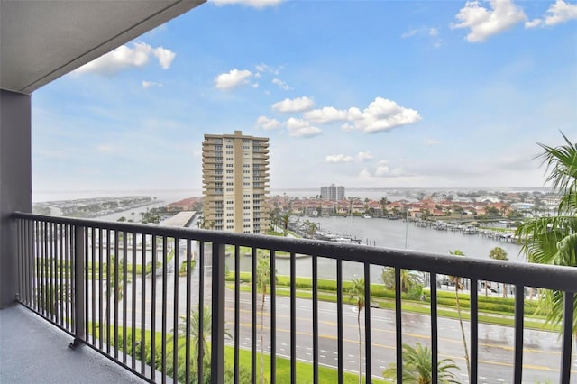 balcony with a water view and a view of city