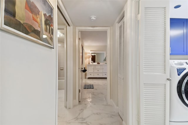 washroom featuring washer / clothes dryer, marble finish floor, and laundry area