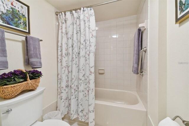 full bathroom with shower / bath combo with shower curtain and toilet