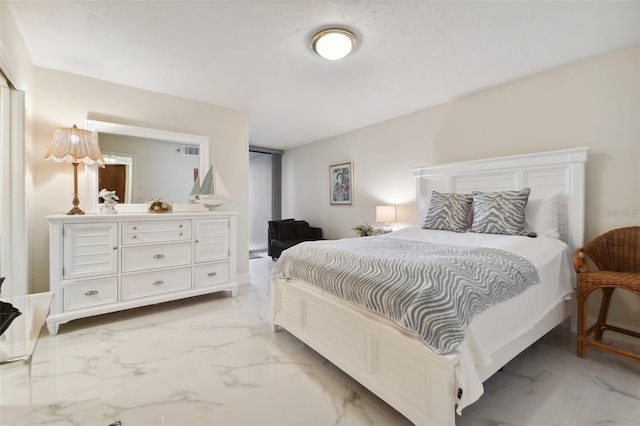 bedroom featuring visible vents and marble finish floor