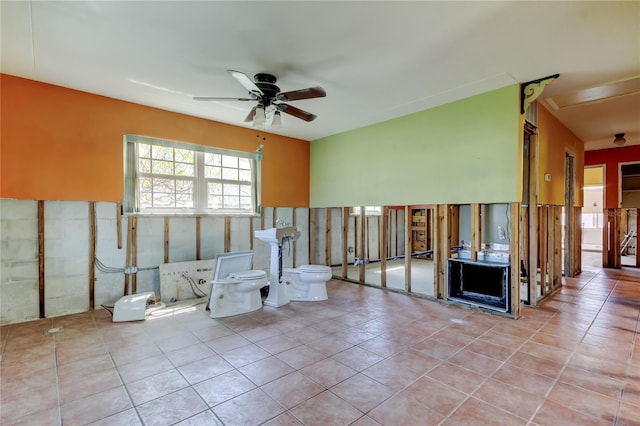 interior space featuring tile patterned floors and a ceiling fan