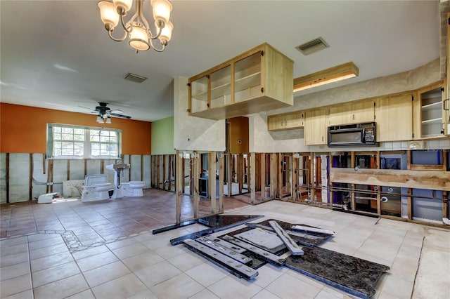 workout area with light tile patterned floors, visible vents, and ceiling fan with notable chandelier