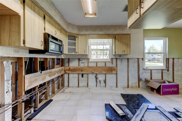 kitchen with a wealth of natural light, visible vents, and black microwave