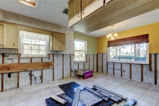 kitchen featuring an inviting chandelier, decorative light fixtures, light tile patterned floors, and visible vents