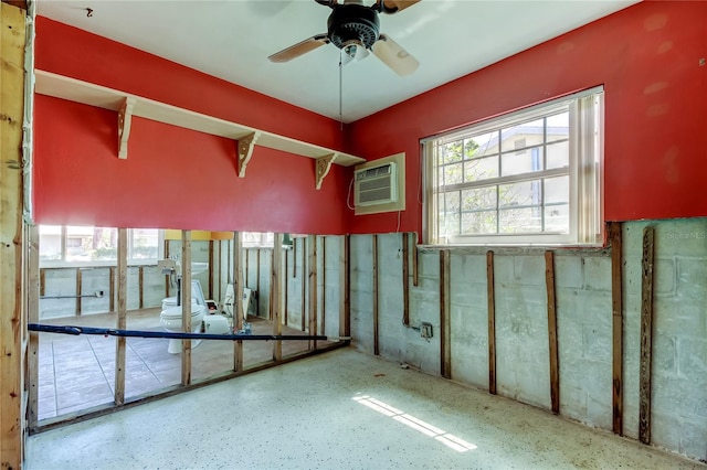 interior space with an AC wall unit and ceiling fan