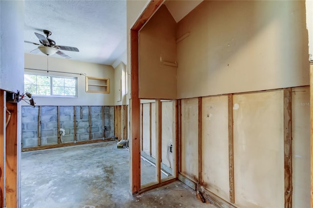 interior space with concrete floors and a ceiling fan