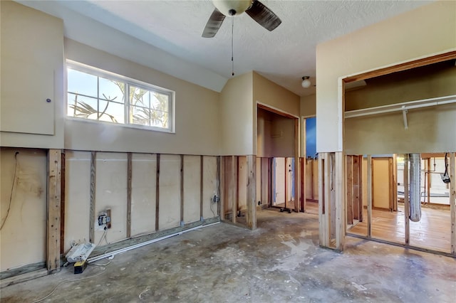 interior space with a textured ceiling and ceiling fan