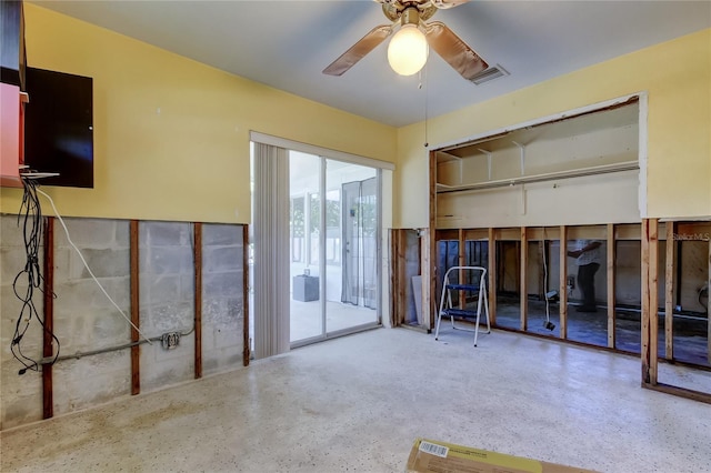 interior space featuring speckled floor and ceiling fan