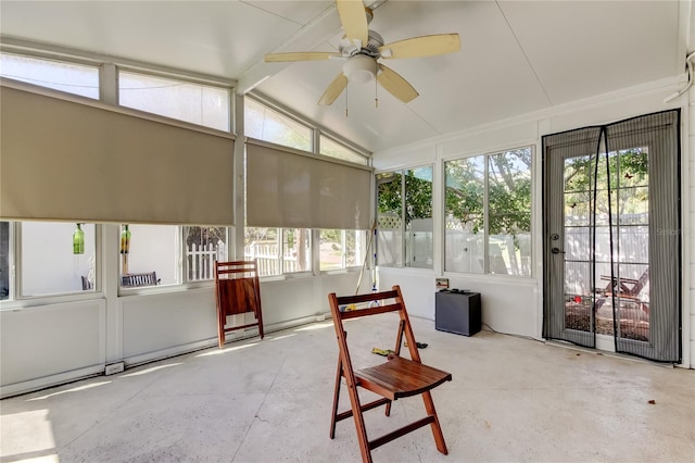 sunroom / solarium with lofted ceiling with beams and a ceiling fan