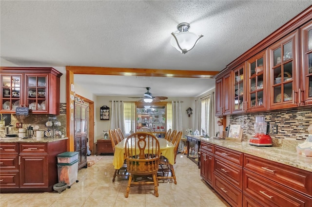 dining area featuring light tile patterned floors, a textured ceiling, and a ceiling fan