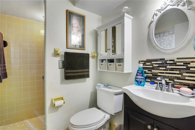 full bathroom with decorative backsplash, toilet, vanity, and a tile shower