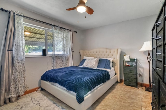 tiled bedroom with a ceiling fan and baseboards