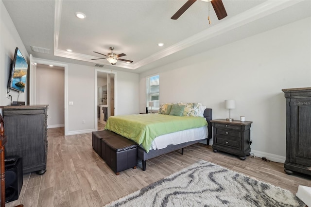 bedroom featuring a tray ceiling, light wood-style flooring, recessed lighting, and baseboards