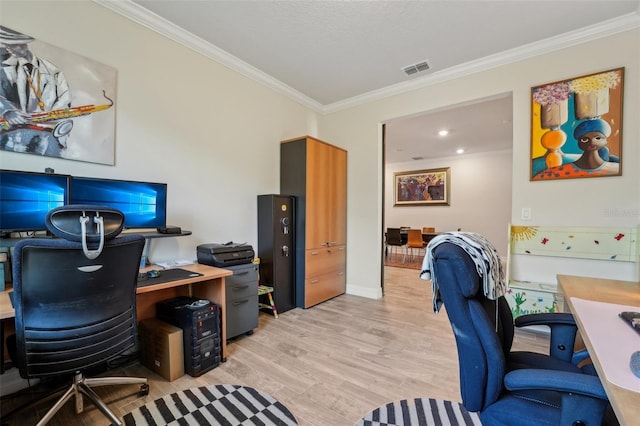 office space featuring crown molding, visible vents, and light wood-type flooring