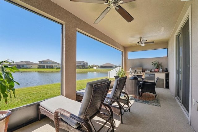 view of patio / terrace with a water view, area for grilling, ceiling fan, and outdoor dining space