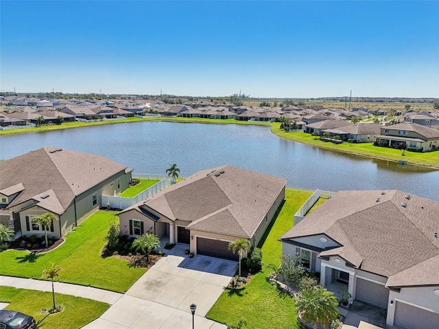 birds eye view of property with a residential view and a water view