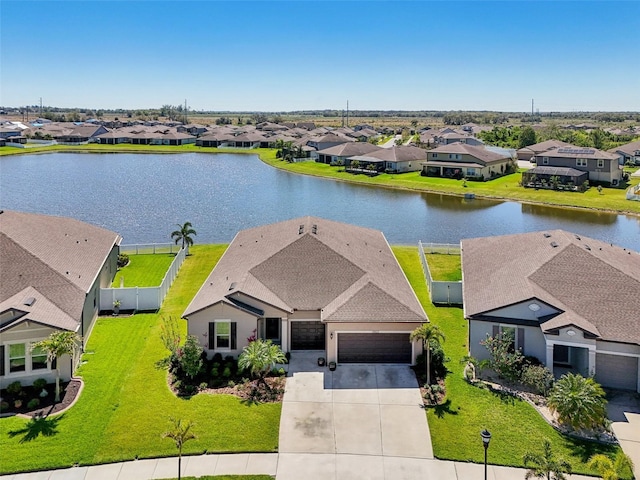 birds eye view of property with a residential view and a water view