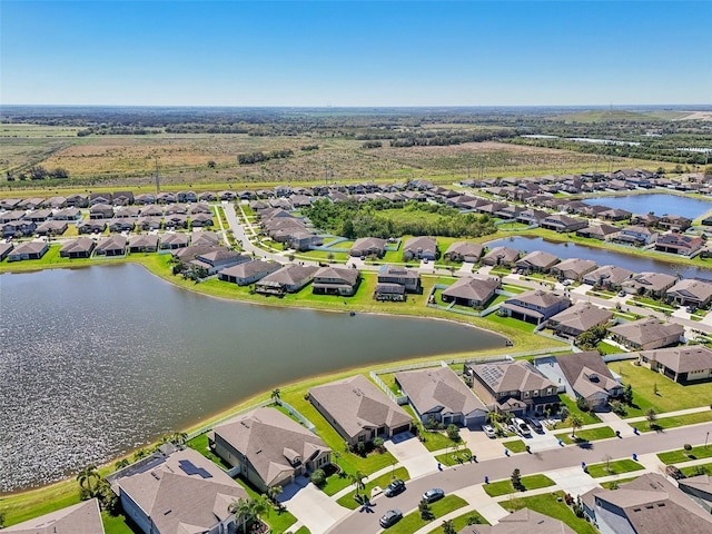 drone / aerial view with a residential view and a water view