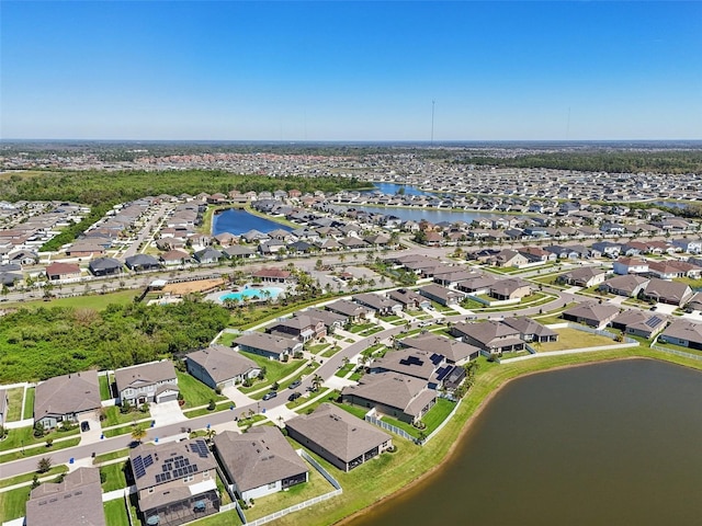 drone / aerial view featuring a water view and a residential view