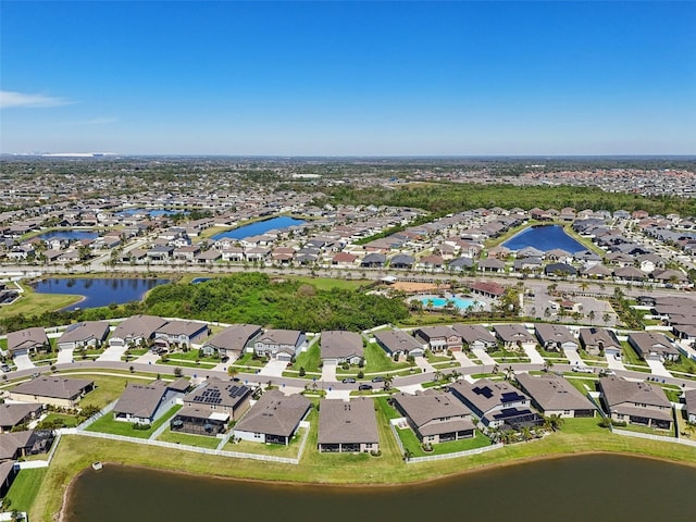 drone / aerial view with a residential view and a water view