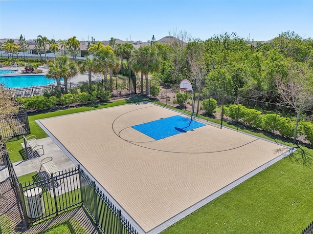 view of basketball court with community basketball court, a lawn, a community pool, and fence