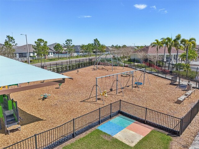 view of community featuring a residential view, playground community, and fence