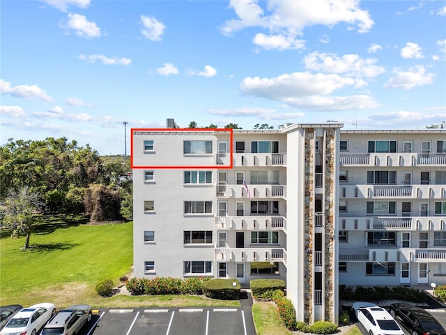 view of apartment building / complex featuring uncovered parking