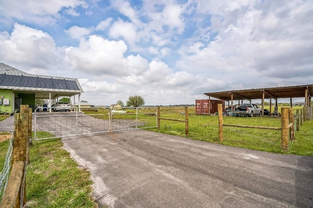 view of street featuring aphalt driveway, a gated entry, and a gate