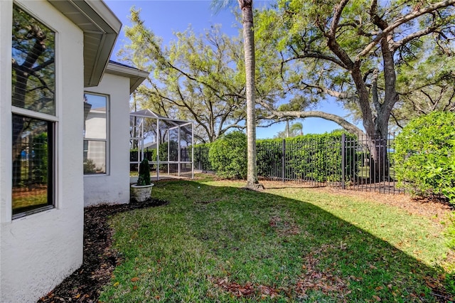 view of yard featuring a lanai and a fenced backyard