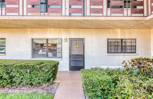 property entrance featuring stucco siding