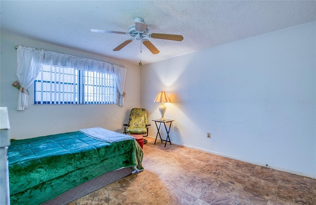 bedroom featuring a textured ceiling, baseboards, and a ceiling fan