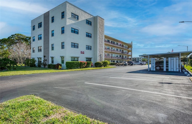 view of building exterior with uncovered parking