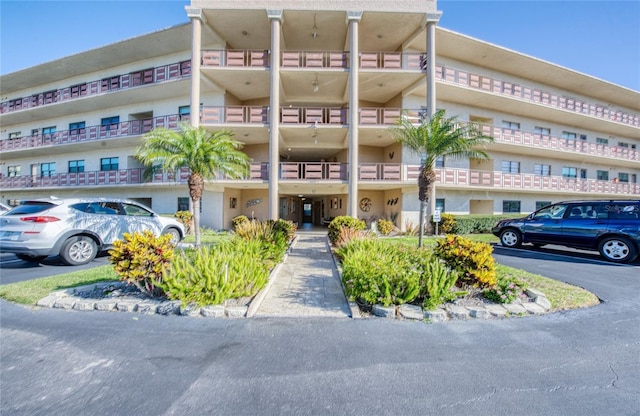 view of building exterior featuring uncovered parking