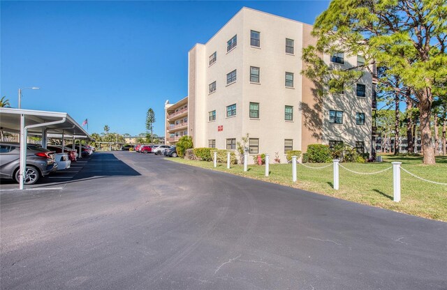 view of property with covered and uncovered parking