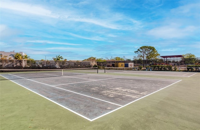 view of tennis court with fence