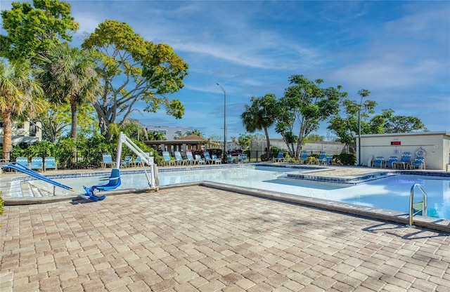 community pool featuring a patio and fence