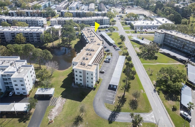 birds eye view of property featuring a city view and a water view