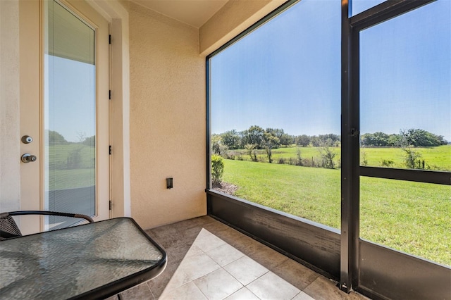 sunroom featuring a rural view