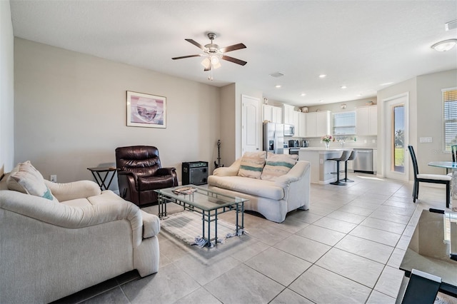 living area with light tile patterned flooring, a ceiling fan, and recessed lighting