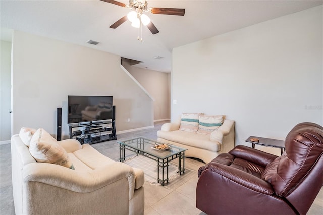 living area featuring light tile patterned floors, visible vents, baseboards, and ceiling fan