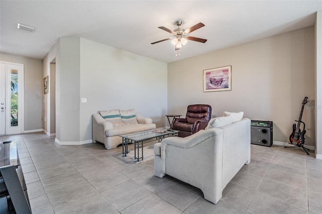 living area with light tile patterned floors, baseboards, and a ceiling fan