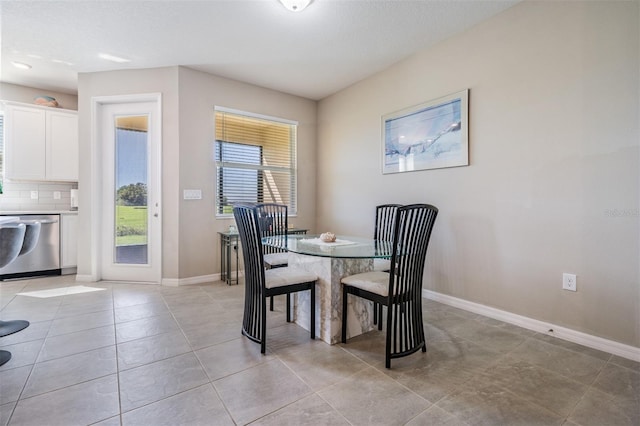 dining room featuring light tile patterned floors and baseboards