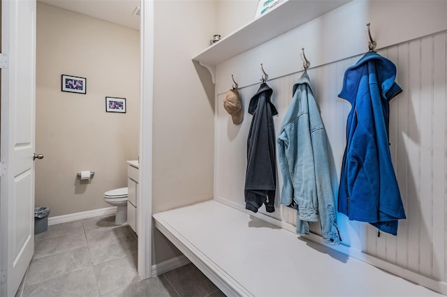 mudroom featuring light tile patterned floors and baseboards