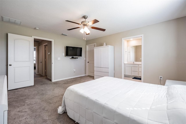 carpeted bedroom featuring connected bathroom, visible vents, baseboards, and ceiling fan