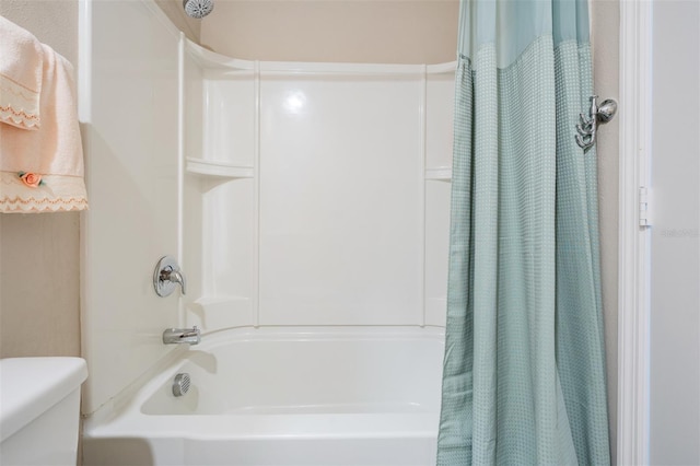 bathroom featuring toilet and shower / bath combination with curtain