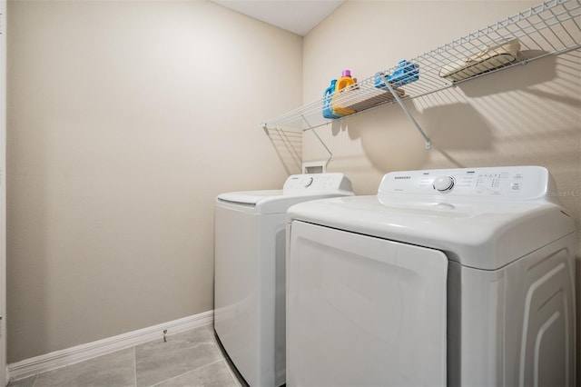 laundry area featuring tile patterned flooring, laundry area, baseboards, and independent washer and dryer